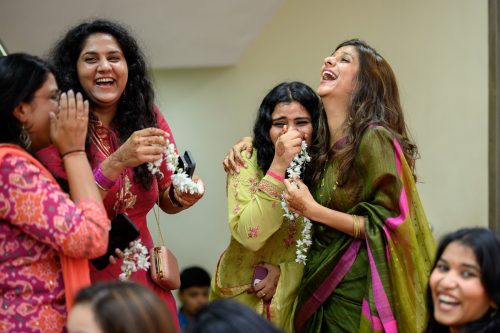 Bride’s friends laughing while playing with garlands during Maharashtrian wedding Pune