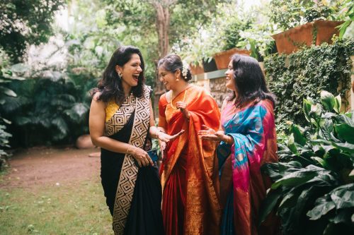 Bride laughing with friends during intimate Marathi home wedding at Jackfruit Tree Pune