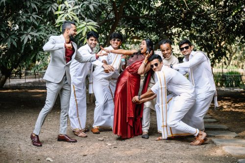 Bride and groom’s friends having fun and posing playfully during Tamil wedding at Ecoville Pune