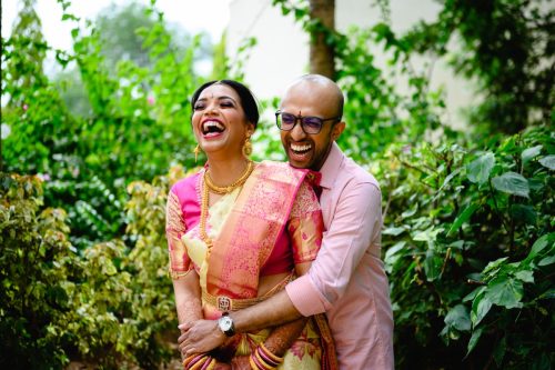 Bride and groom laughing together during candid couple portraits at a Pune telugu malayalam wedding at Hyatt, Pune