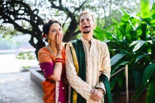 Bride and groom laughing during natural couple portraits at a maharashtrian wedding at Siddhi Saaz, Pune