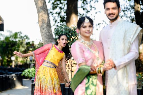 Cousin photobombing couple portrait during wedding at Turf club Pune