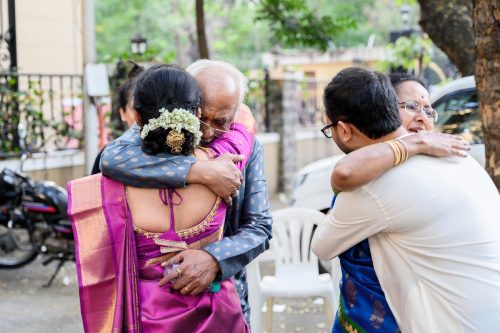Bride and family sharing emotional hugs during bidaai at Tamil Brahmin wedding in Pune