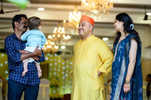 Father making funny faces at a baby during Marathi wedding at Munot Karayalay Pune