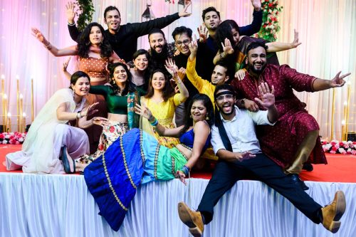 Group of friends laughing and posing together during sangeet night at Siddhi Saaz Pune wedding
