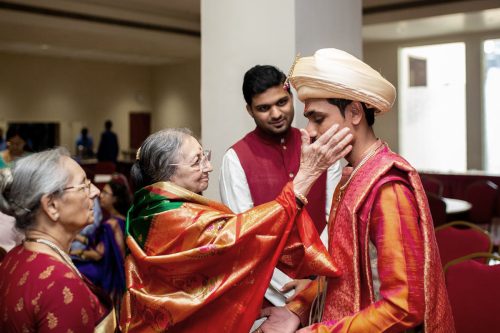 Grandmother blessing groom before Maharashtrian wedding ceremony at Vishnukrupa Hall Pune