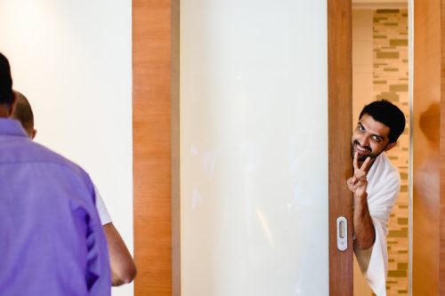 Groom’s brother peeking and posing playfully during wedding in Pune
