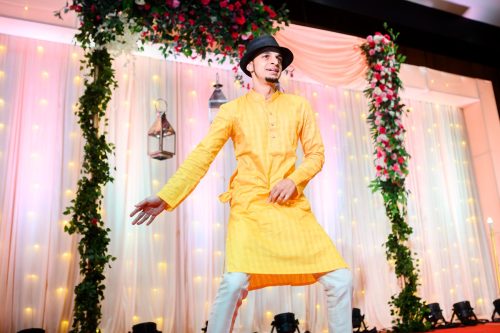 Groom performing dance with hat during sangeet night at Siddhi Saaz Pune wedding
