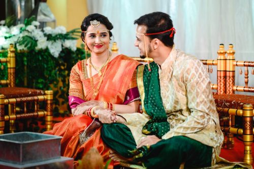 maharashtrian bride looking at groom while holding hands during wedding ceremony