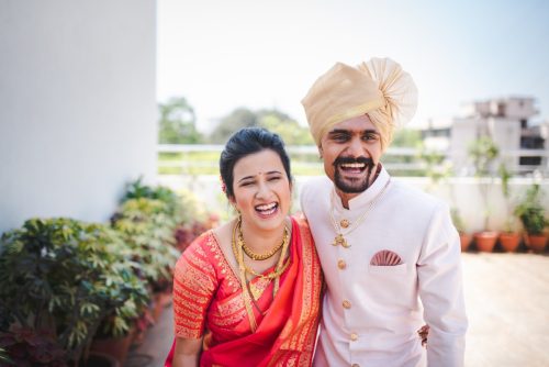 Bride and groom laughing together during Maharashtrian wedding couple portraits at Vishnukrupa hall, pune