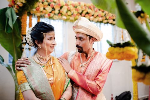 bride smiling at groom & groom looks shocked. Funny moment during saptapadi marathi wedding