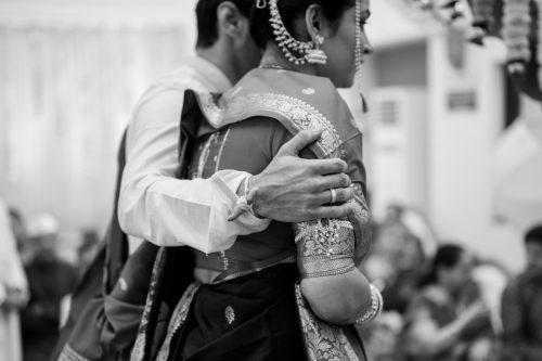 groom holding bride reassuringly during saptapadi marathi wedding ceremony