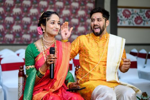 groom laughing as bride says ukhana during marathi wedding