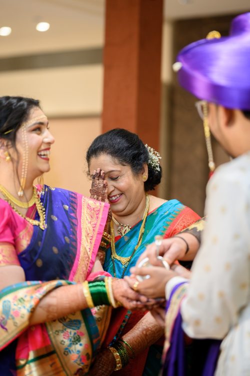 Mother of bride smiling shyly during Kanyadaan ceremony at Marathi wedding Harshall Hall Pune