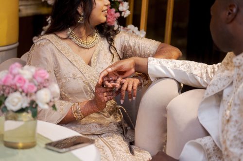 bride and groom holding hands during nikah reception speech