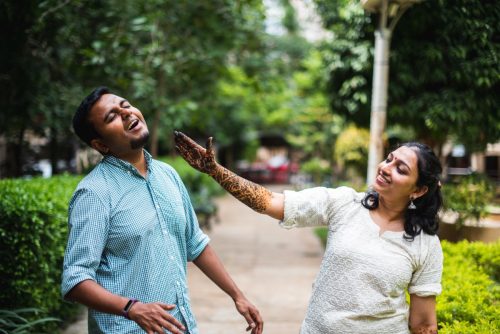 Bride playfully teasing groom during candid mehendi couple portraits