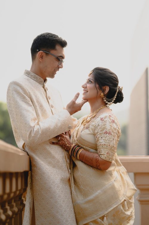 Bride and groom sharing a romantic moment as the groom gently touches her brides chin during elegant wedding couple portraits
