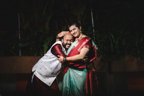 A romantic couple hugging each other and winking. Candid fun moment in the evening at Shruti mangal karayalaya, pune