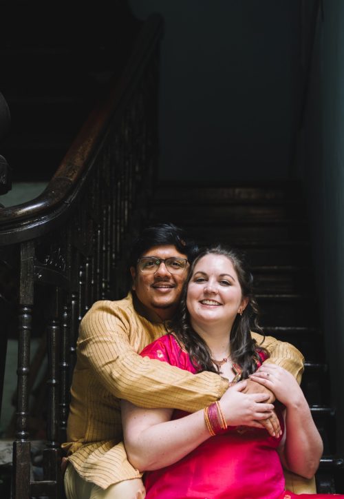 Bride and groom hugging on staircase during romantic during thier pre wedding shoot at their home in pune