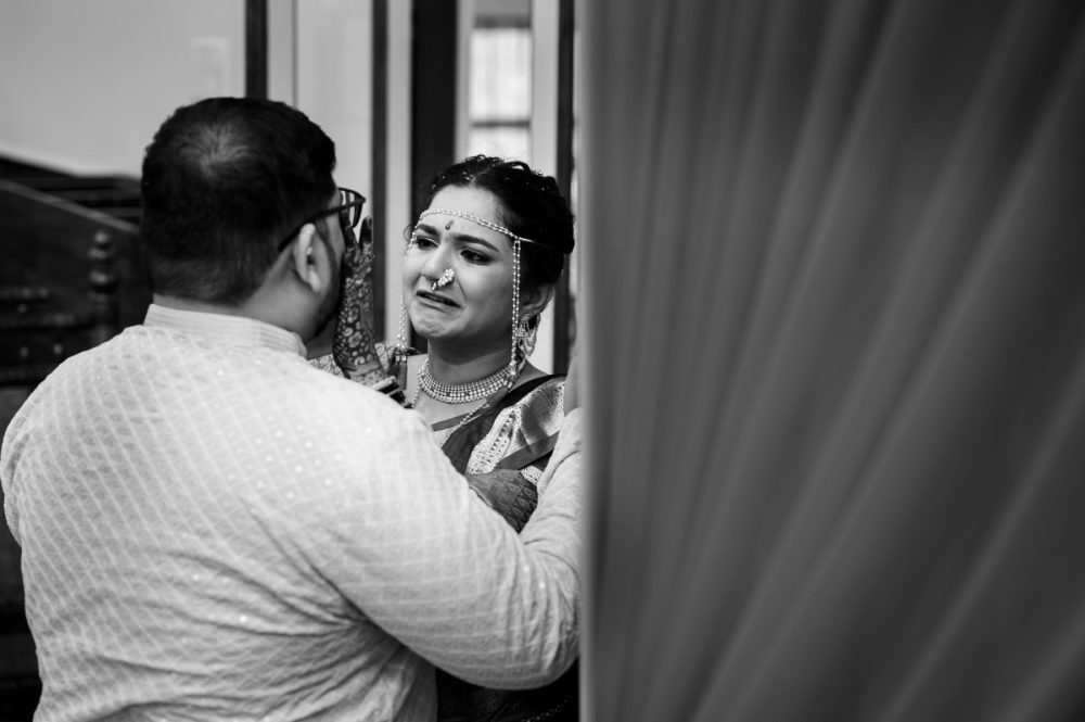 Bride crying as her brother comforts her after mangalashtaka during Maharashtrian wedding at Pune