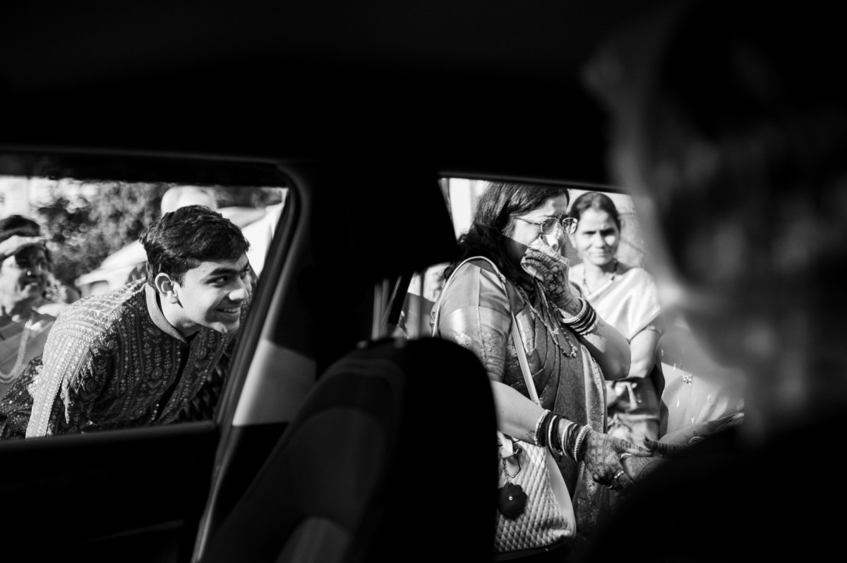 Emotional bidaai moment as mother wipes tears while brother smiles beside the car at vishnukrupa hall, pune