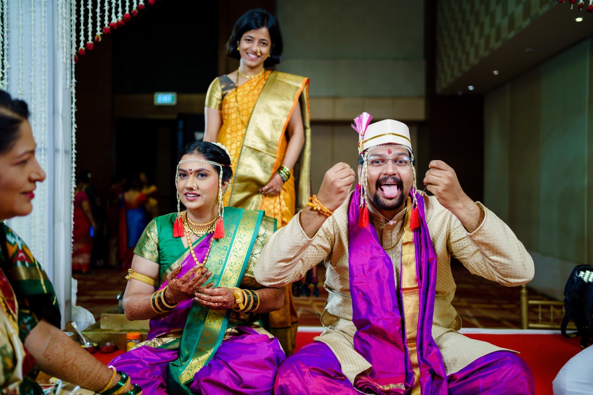 Groom playfully teasing while holding mangalsutra during Maharashtrian wedding ceremony at hyatt, pune