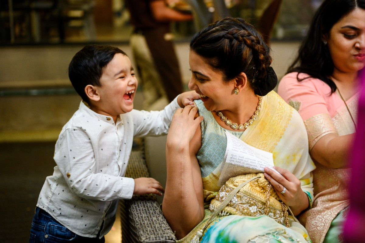 Little boy laughing with his sister during engagement ceremony at Roots 9 Pune